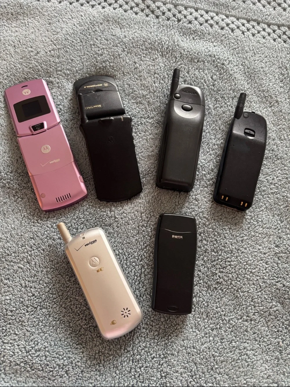 Vintage Collection of cell phones includes StarTAC and Pink Flip